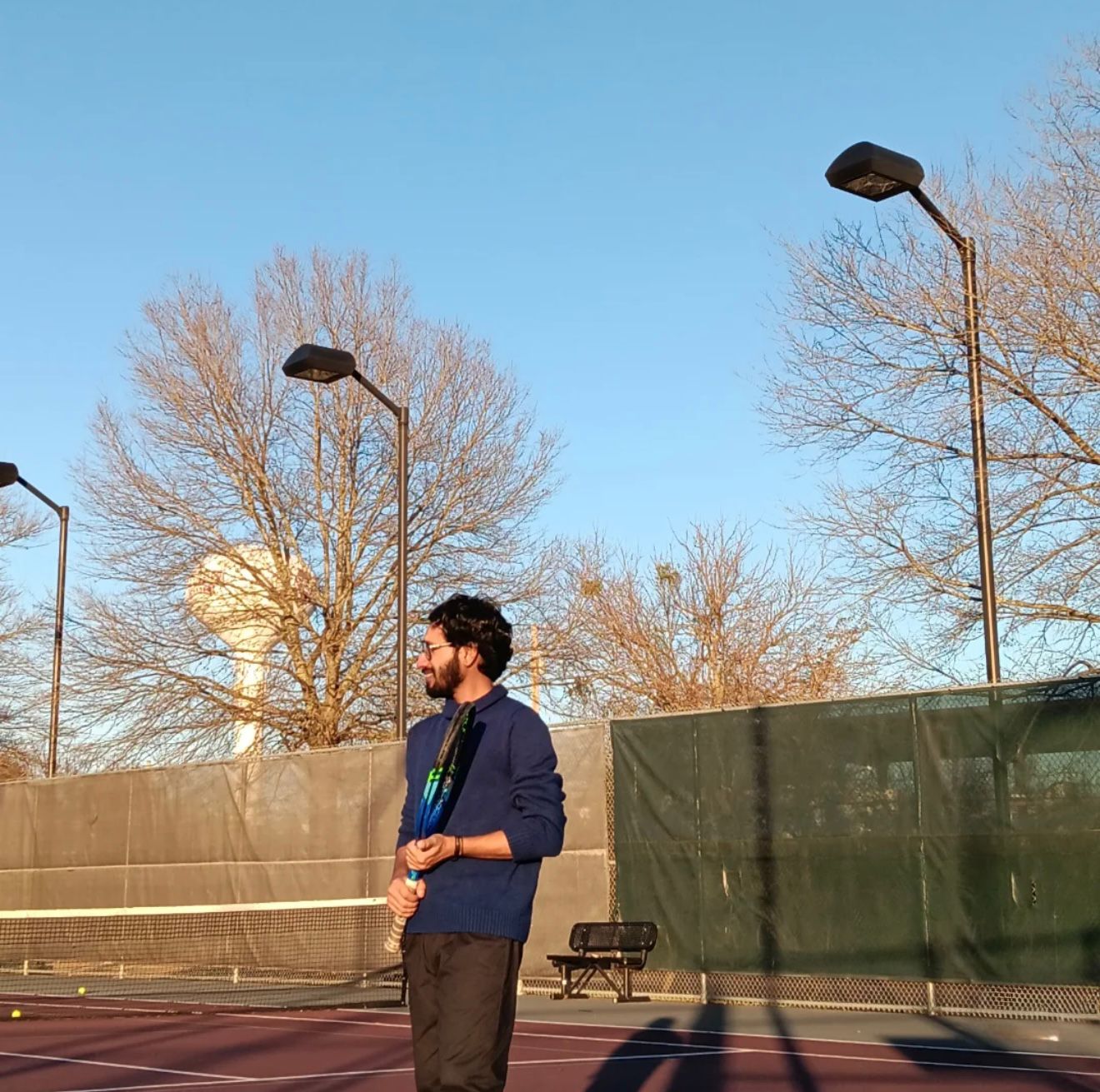 Elias on the tennis court at golden hour