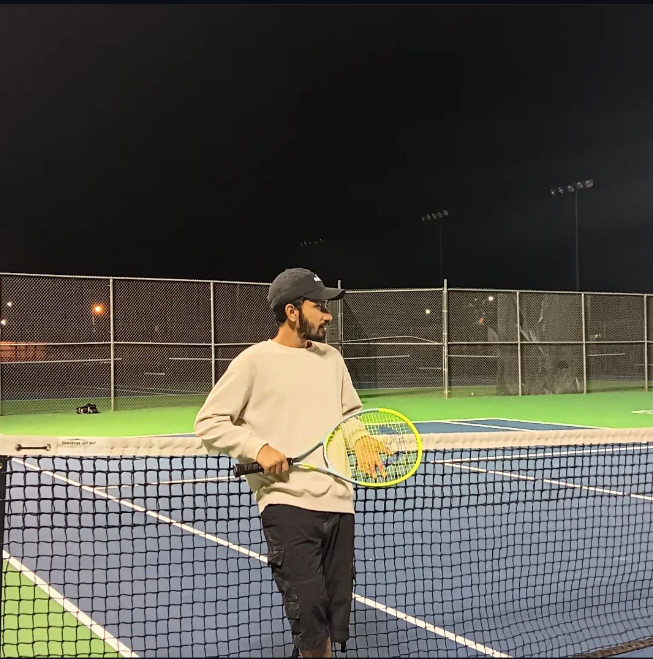 Elias at the net under floodlights